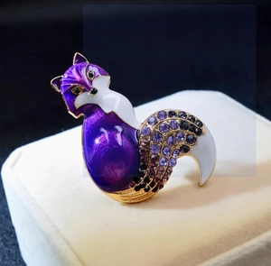 Detailed close-up of fox brooch featuring purple enamel gradient and inlaid rhinestones