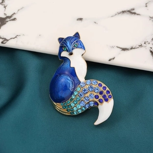 Elegant fox brooch with deep blue enamel and sparkling crystals on a golden metal base