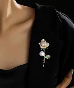 Detail of rose brooch with white diamonds, green leaves and a large round pearl