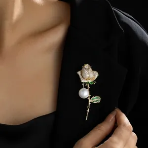 Elegant rose brooch with diamonds and pearl pinned on a professional black blazer suit