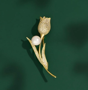 Detailed view of tulip brooch with white zircon petals and a central pearl setting