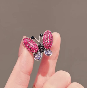 Exquisite gold-plated butterfly brooch with purple rhinestones and pink crystal details