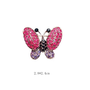 Elegant gold butterfly brooch with purple and pink rhinestones in a centered studio view
