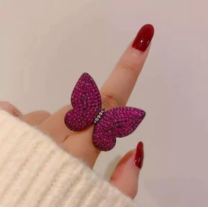 Macro shot of luxury butterfly ring with vibrant pink crystals and silver details
