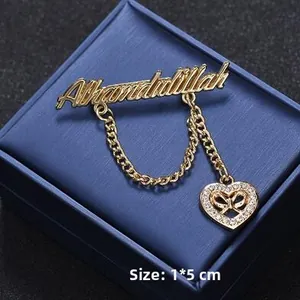 Detailed close-up of golden Alhamdulillah brooch with heart pendant and 1x5cm size