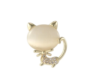 Close-up of golden cat brooch featuring white opal head and sparkling cubic zirconia stones