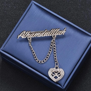 Close-up of silver Alhamdulillah brooch with double chains and a zircon heart pendant