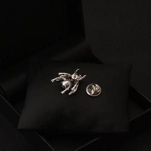 Close-up of vintage bee brooch back with silver alloy pin and metal clutch fastener