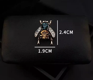 Detail showing vintage bee brooch dimensions 2.4cm by 1.9cm with blue and amber crystal