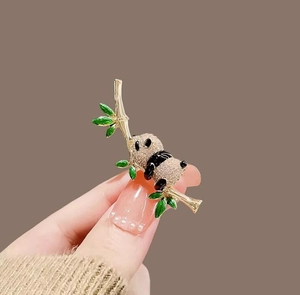 Detail of panda bamboo brooch with gold alloy, white zircons and green enamel