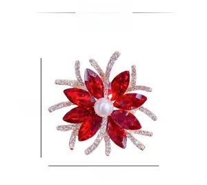 Detail of flower brooch with red crystals, white pearl center and 4cm dimensions