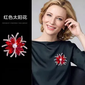 Elegant red sunflower brooch featuring marquise crystals and a pearl center on gold alloy