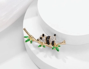 Close-up of panda brooch with sparkling crystals and green enamel bamboo leaves