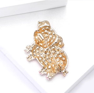 Detail view of the secure safety pin clasp on the back of a pink pig animal brooch