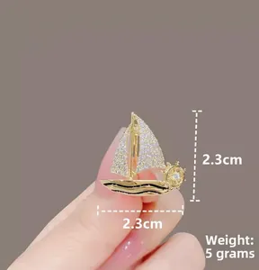 Detail of 2.3cm gold sailboat brooch with clear cubic zirconia pavé and 5g weight