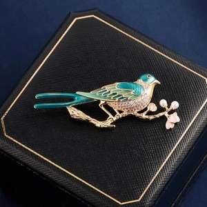 Vintage magpie bird brooch with enamel and white pearls on elegant gold branch