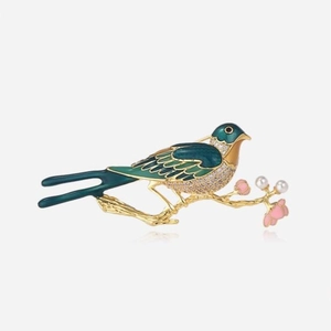 Vintage magpie bird brooch in gold with green enamel and sparkling crystals