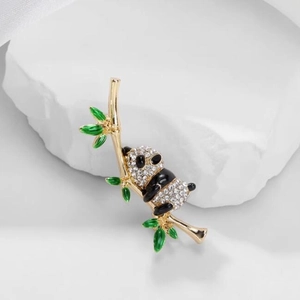 Chinese style panda and bamboo brooch with white crystals and gold plating finish