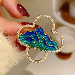 Chinese landscape brooch with blue enamel mountains and sparkling crystal border for coats