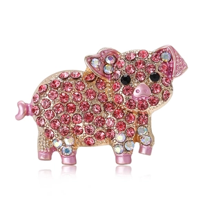 Detail of pig brooch with pink rhinestones, gold plating, and reflective surface