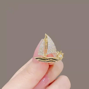 Elegant gold sailboat brooch for women with micro-pave zircons and nautical design