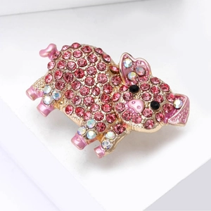 Sparkling pink pig brooch with crystals and enamel finish on elegant white display