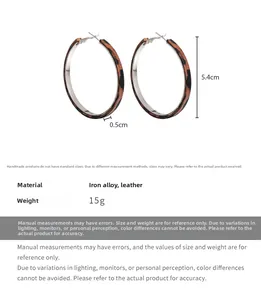 Detail view of leopard print leather earrings with 5.4cm diameter and 15g weight specs