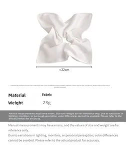 Detail view of a 22cm white satin scarf scrunchie with high-gloss silk texture and 23g weight