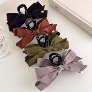 Detailed set of premium velvet bow hair claws with elegant small golden heart charms