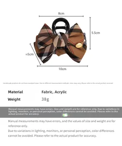 Detail view of British plaid bow hair claw clip showing precise 10cm measurement and fabric