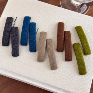 Set of 10 minimalist fabric rectangular hair clips in five colors on a vintage book cover