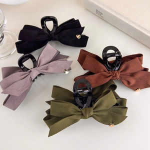 Elegant velvet bow hair claw clips in black, pink, and green with golden heart detail
