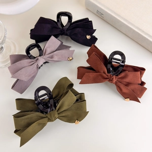 Elegant velvet bow hair claws with gold heart detail in black grey green and caramel