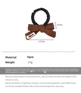 Detail view of brown knit bow hair tie with Nice label and 11cm size measurements