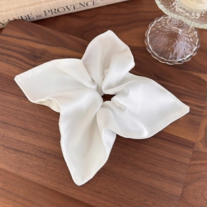 Elegant oversized pearl white satin scrunchie with silky luster for high ponytail styling
