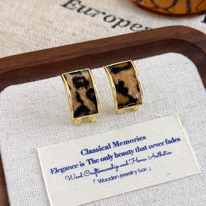 Close-up of vintage leopard print plush square earrings with elegant gold metal frames