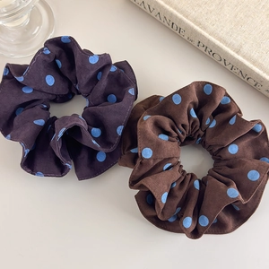 Polka dot hair scrunchies set in purple and brown colors with a retro fabric texture
