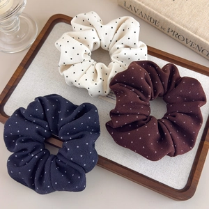 Three-pack of French-style polka dot fabric scrunchies in cream, navy, and brown colors