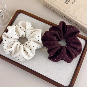 French style polka dot scrunchie set in beige and burgundy on a vintage wood tray