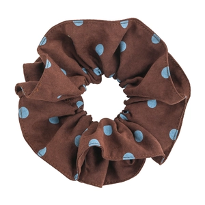 Vintage brown and blue polka dot scrunchie with soft fabric texture on white background
