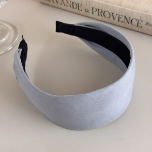 Detail of light blue fabric headband showing twill texture and anti-slip black lining
