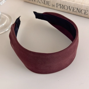Detailed close-up of wine red fabric headband with non-slip interior and fine texture