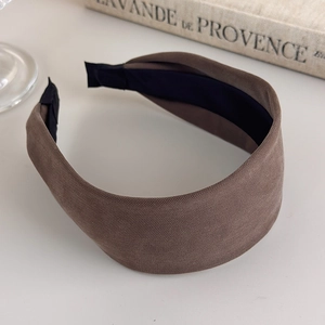 Close-up of wide coffee brown fabric headband with premium textured weave detail