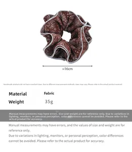 Detail view of brown paisley fabric hair scrunchie with 16cm diameter and 35g weight