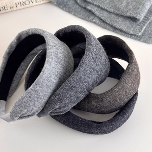 Thick knitted headband for women in grey tones with wool texture for autumn winter fashion