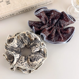 Vintage paisley print oversized scrunchies in brown and beige colors with a retro vibe