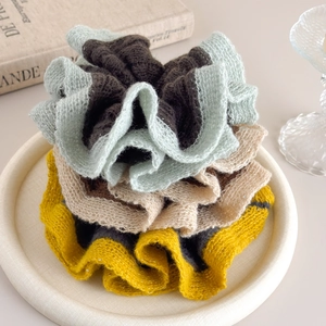 Three-piece knit scrunchies set in neutral colors with subtle sequin edge detailing