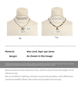 Close-up of tiger eye stone pendants on wax cord necklaces showing two different shapes