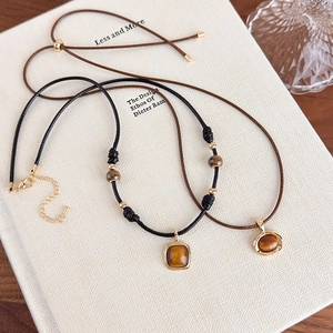 Tiger eye stone pendant necklace on leather cord with adjustable golden beads and metal frame