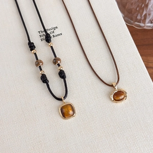 Tiger eye stone pendant necklaces with leather cord showing unique cat-eye effect textures